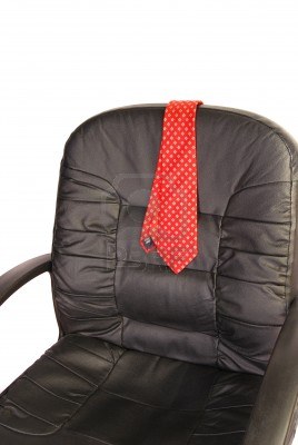 1481330-red-mens-neck-tie-draped-over-the-back-of-a-black-office-desk-chair-iso
